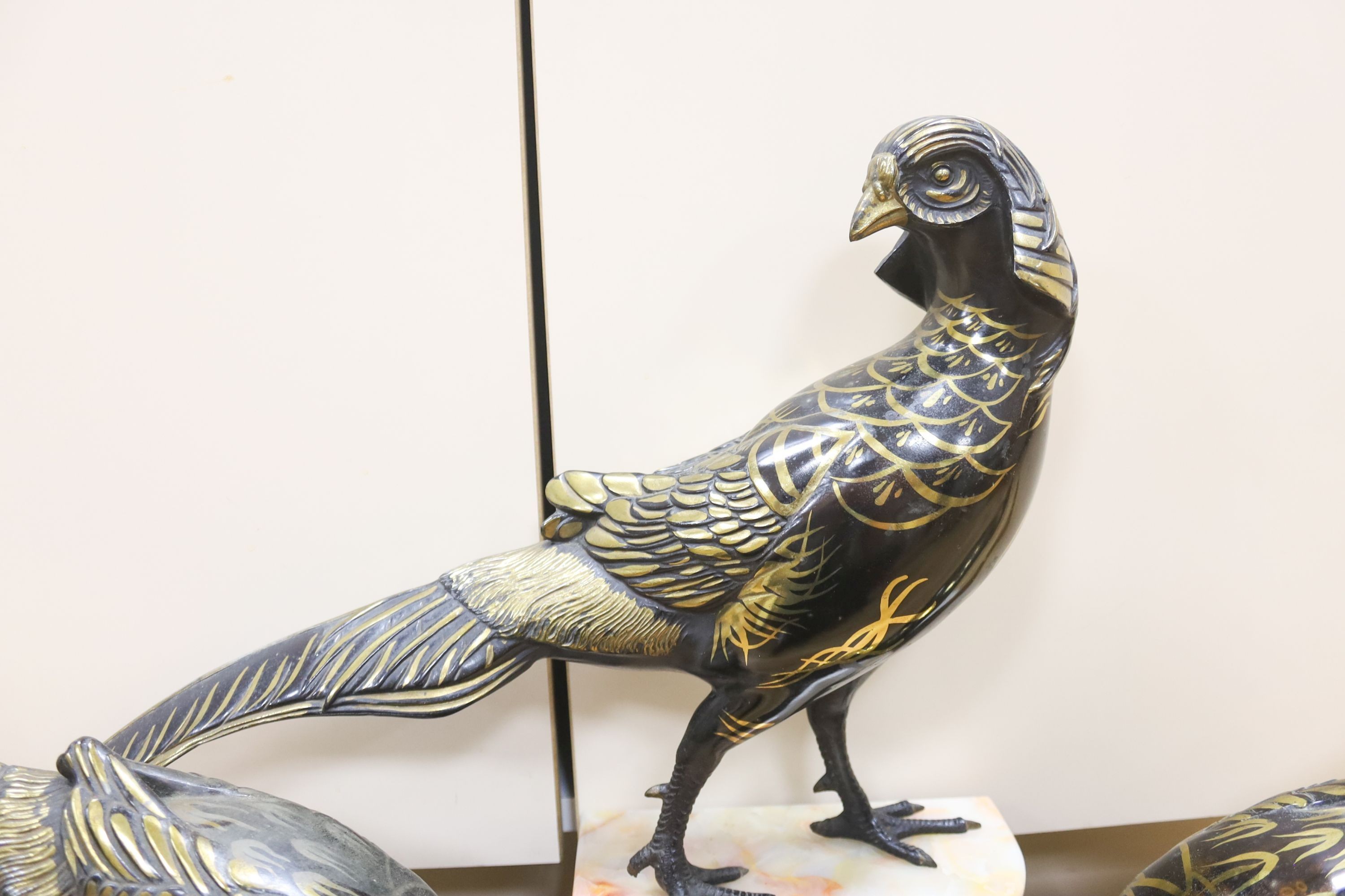 An Art Deco cold painted and gilded spelter model of 3 pheasants on a black and rouge marble base, 89cm